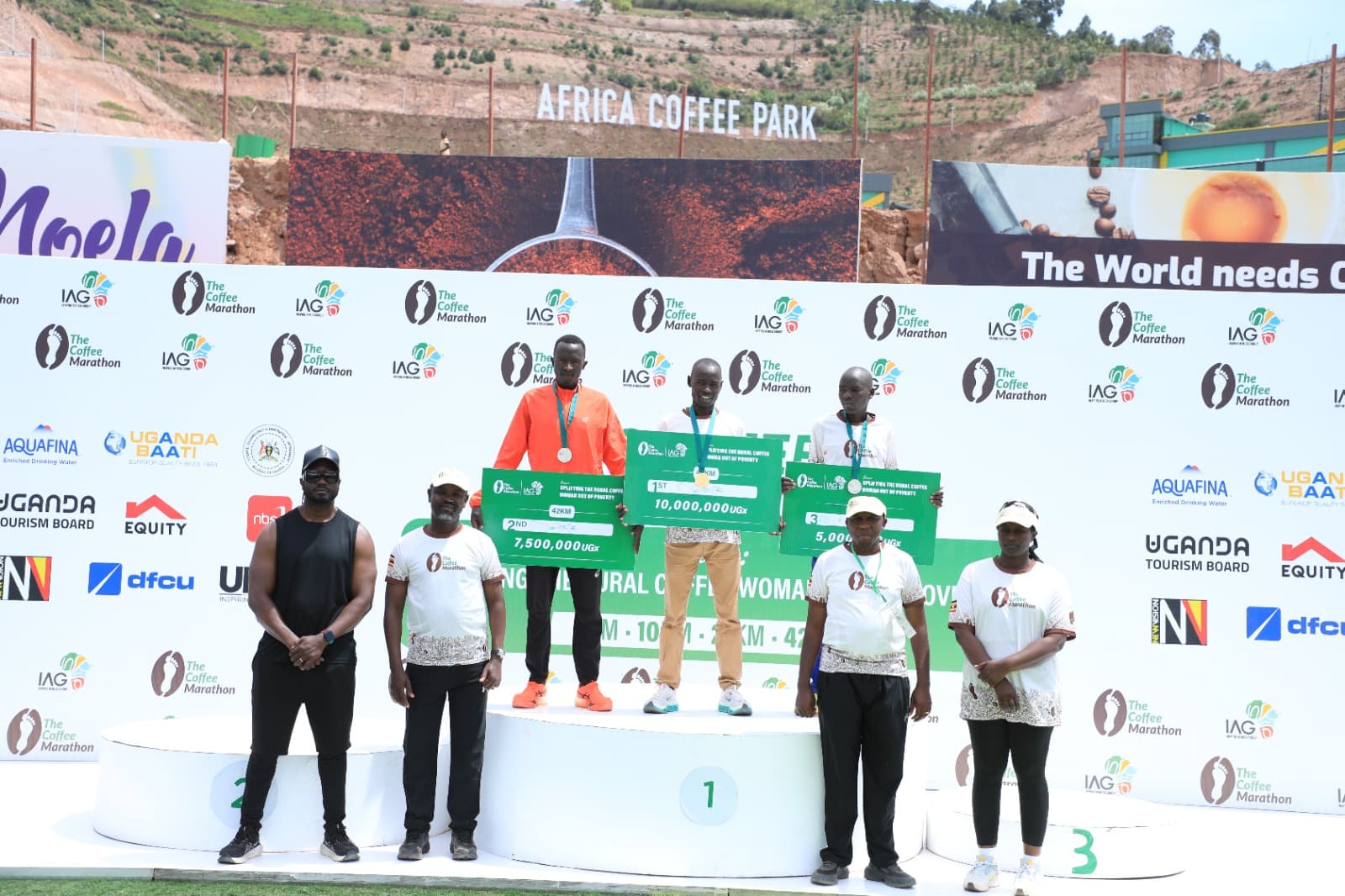Three Coffee Marathon 21km winners raising arms together at the finish line